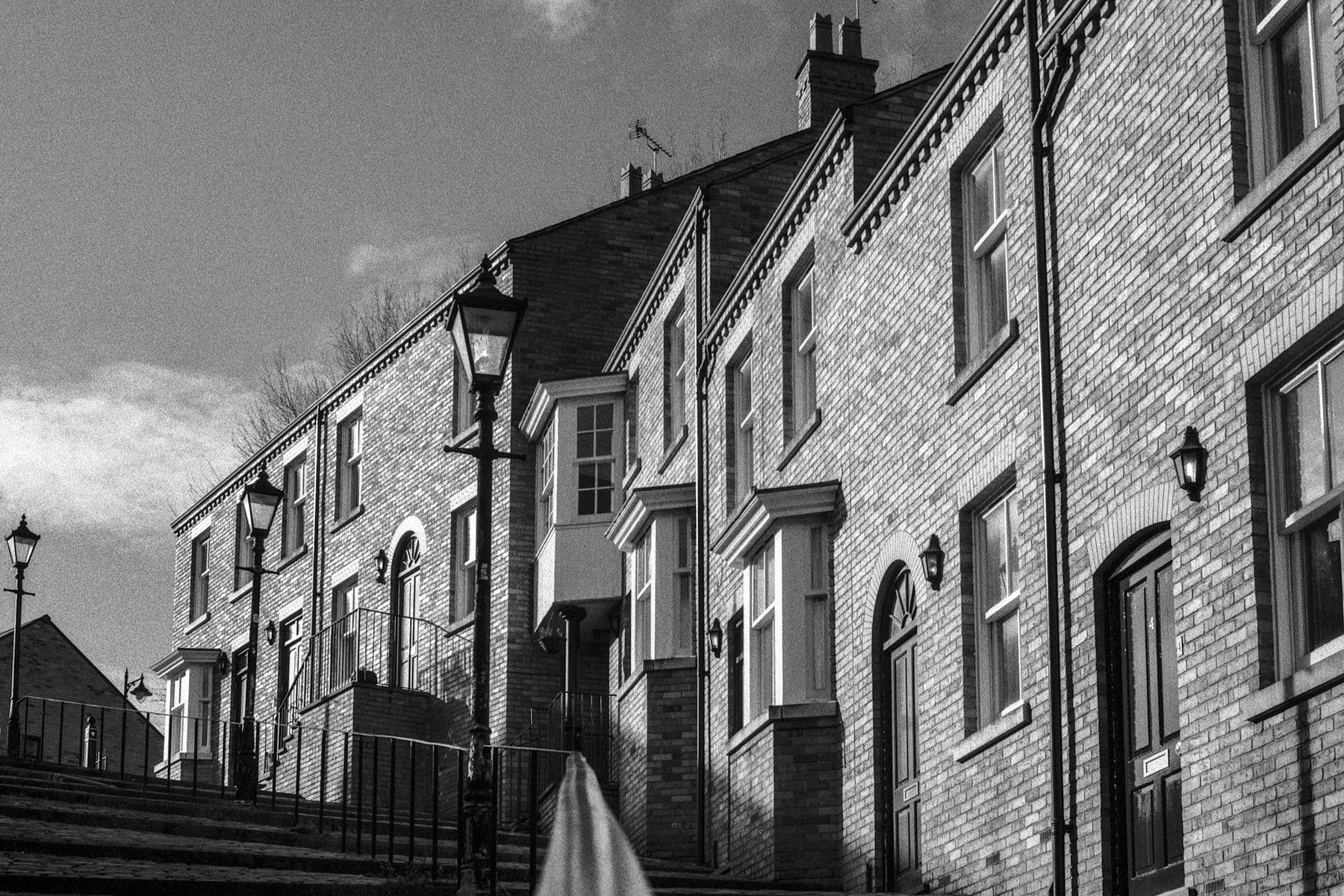 A row of terraced houses in black and white. Illustrative image