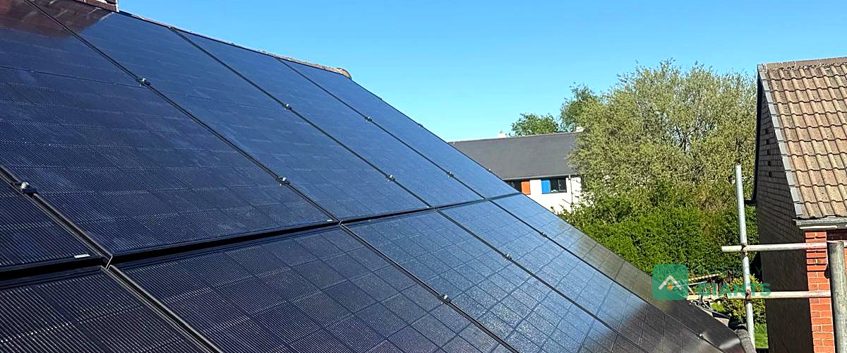 Ten black Aiko solar panels on the due south facing roof of a brick semi in Birstall
