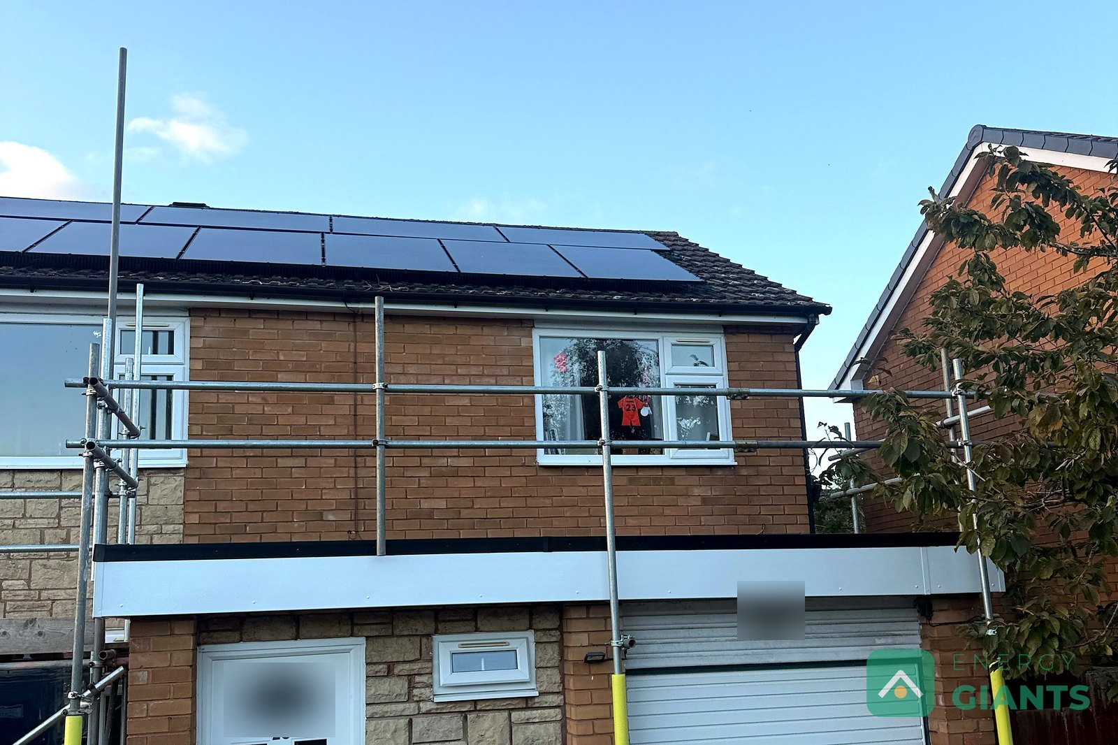 The same house at the end of the day, the garage flat roof finished in black EPDM with new white fascias