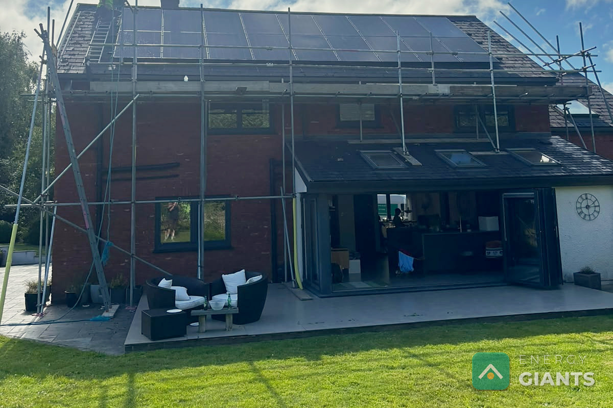The east facing roof from the garden on installation day, eighteen Aiko panels up and the scaffold still standing