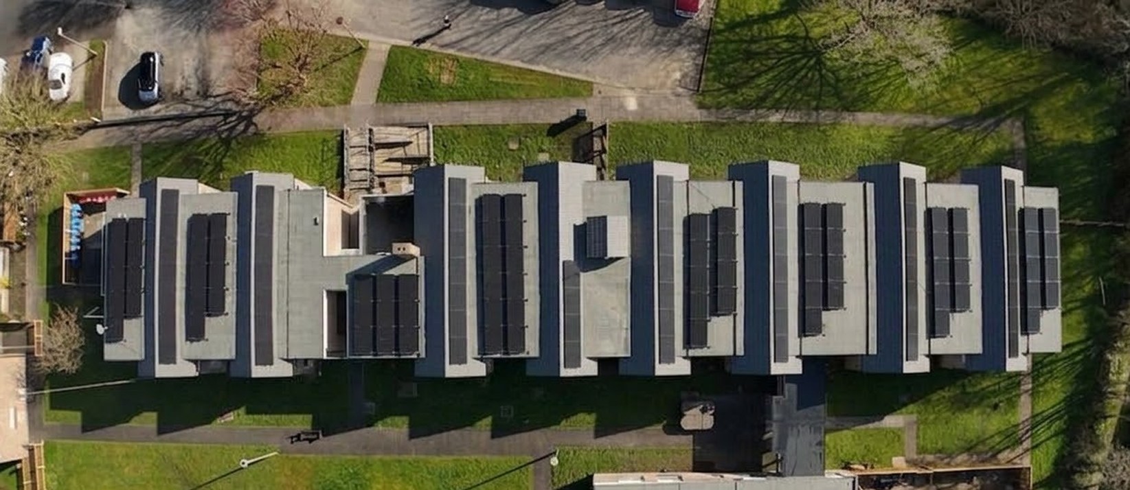 The main block at Torentum Court from above in March 2026, every flat roof renewed and the wider programme complete