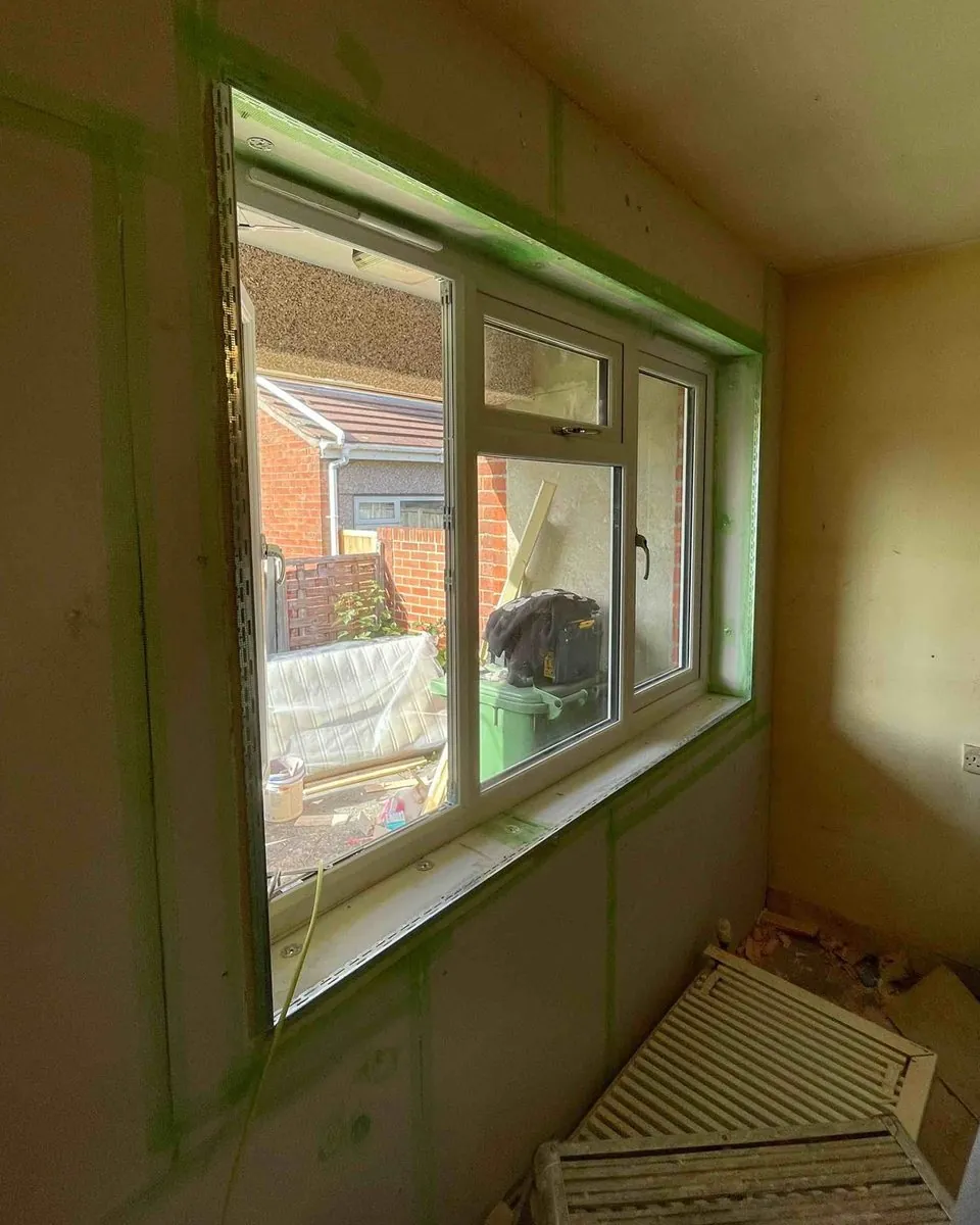 The same bedroom with every board joint scrim taped and metal beads fitted around the window reveal