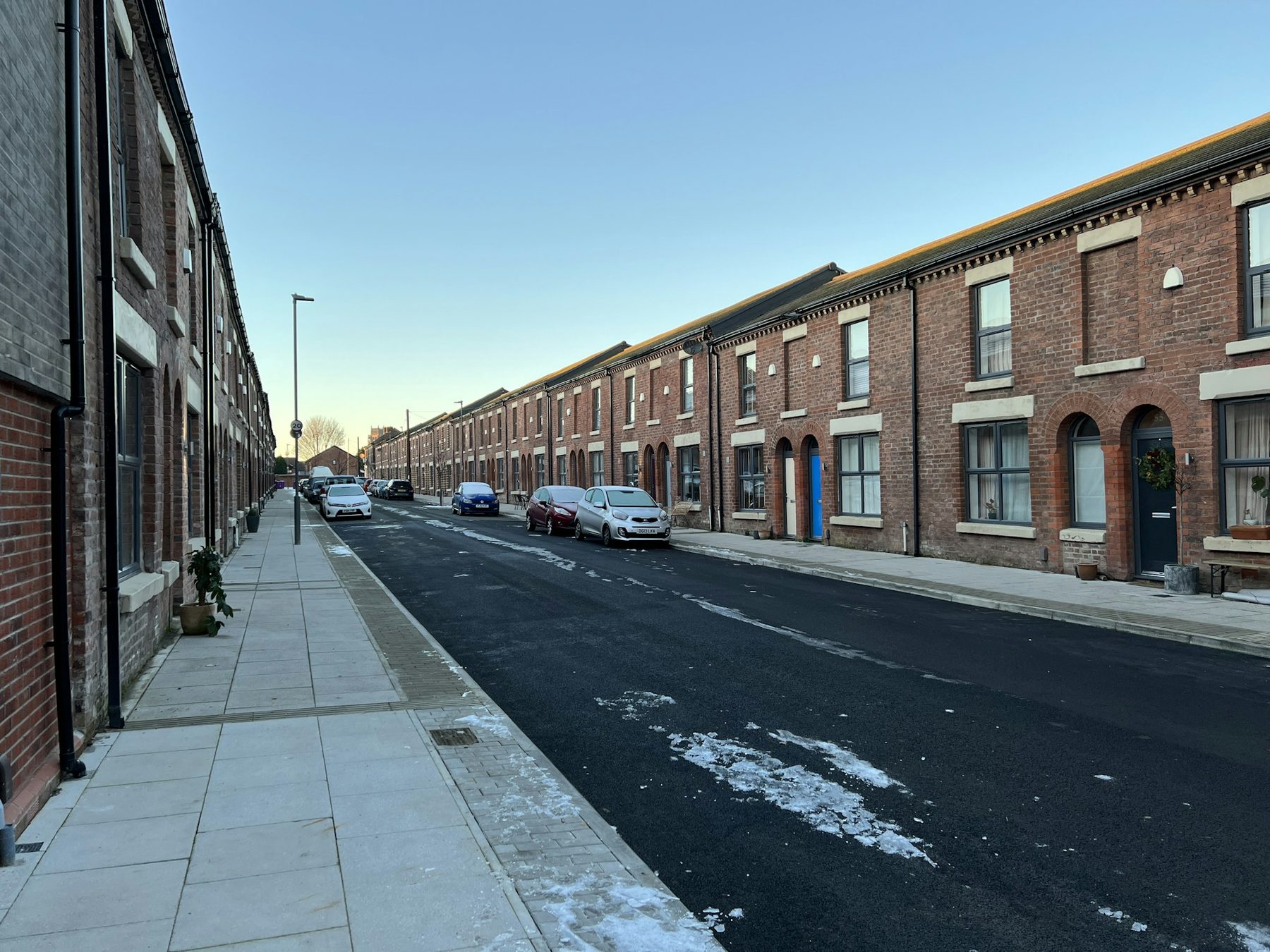 A long street of red brick terraced houses. Illustrative image