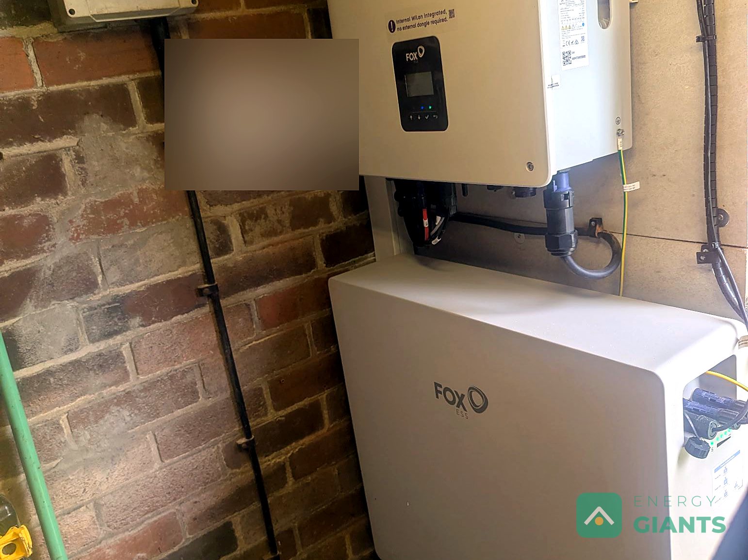 The Fox ESS inverter above the battery on the outbuilding wall