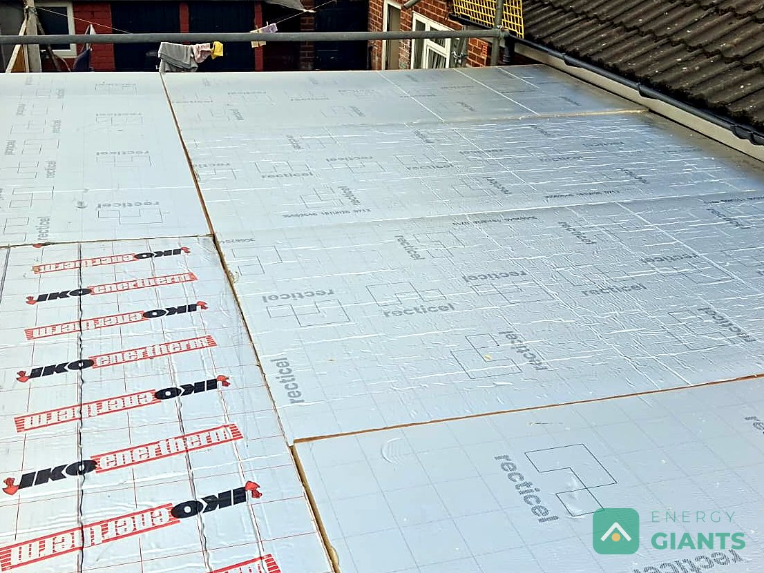 Foil faced PIR insulation boards laid across the extension roof, edge to edge