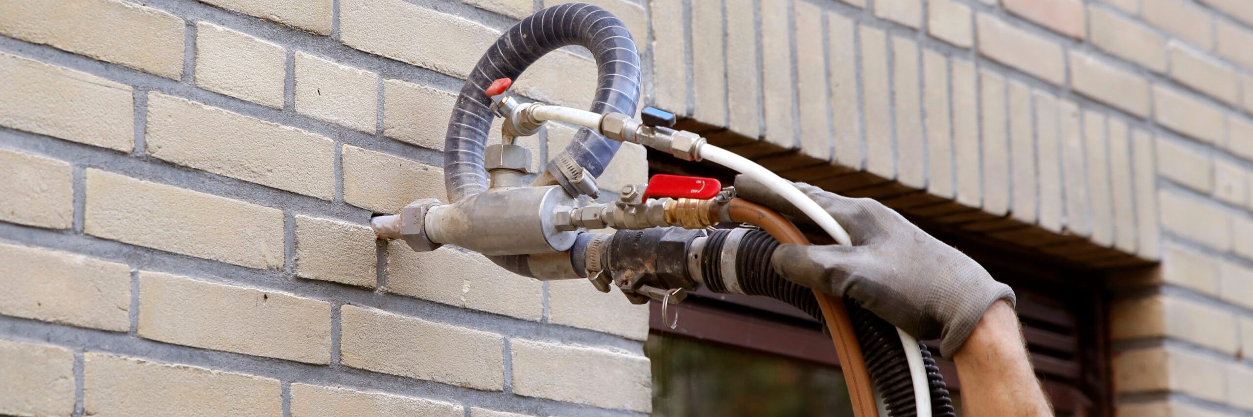 Cavity wall insulation being installed at a property