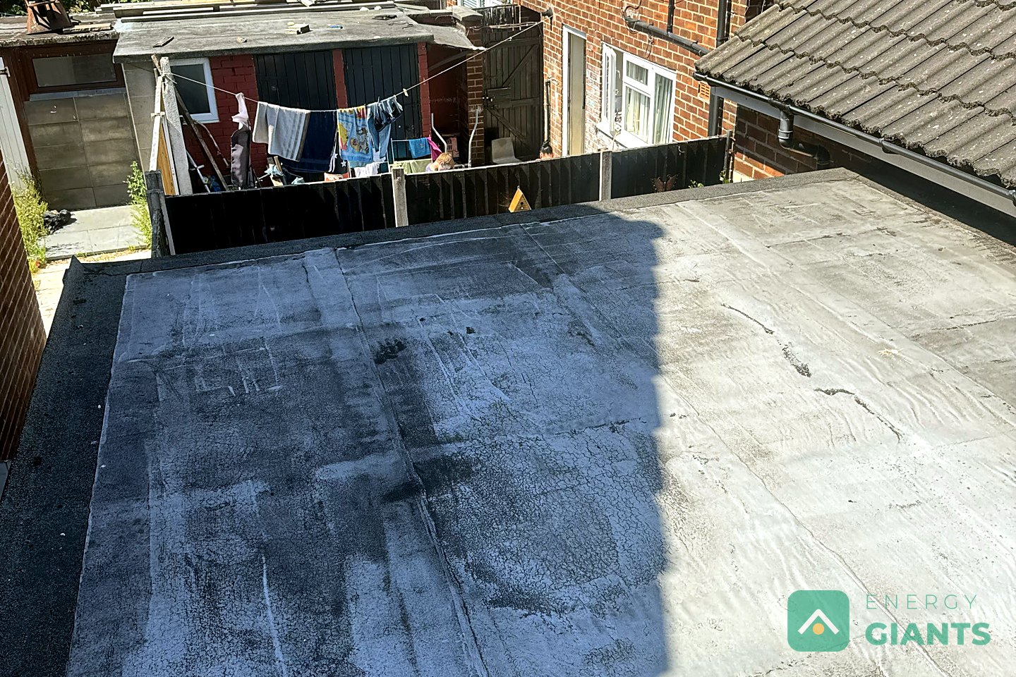 The old felt roof over the rear extension in Litherland at the survey visit, patched and holding water
