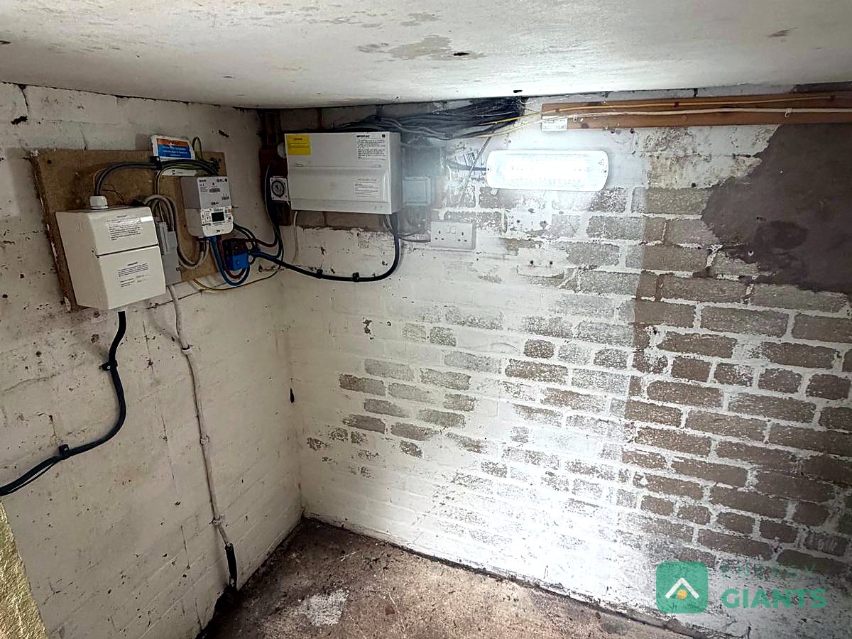 The empty whitewashed outbuilding before the install