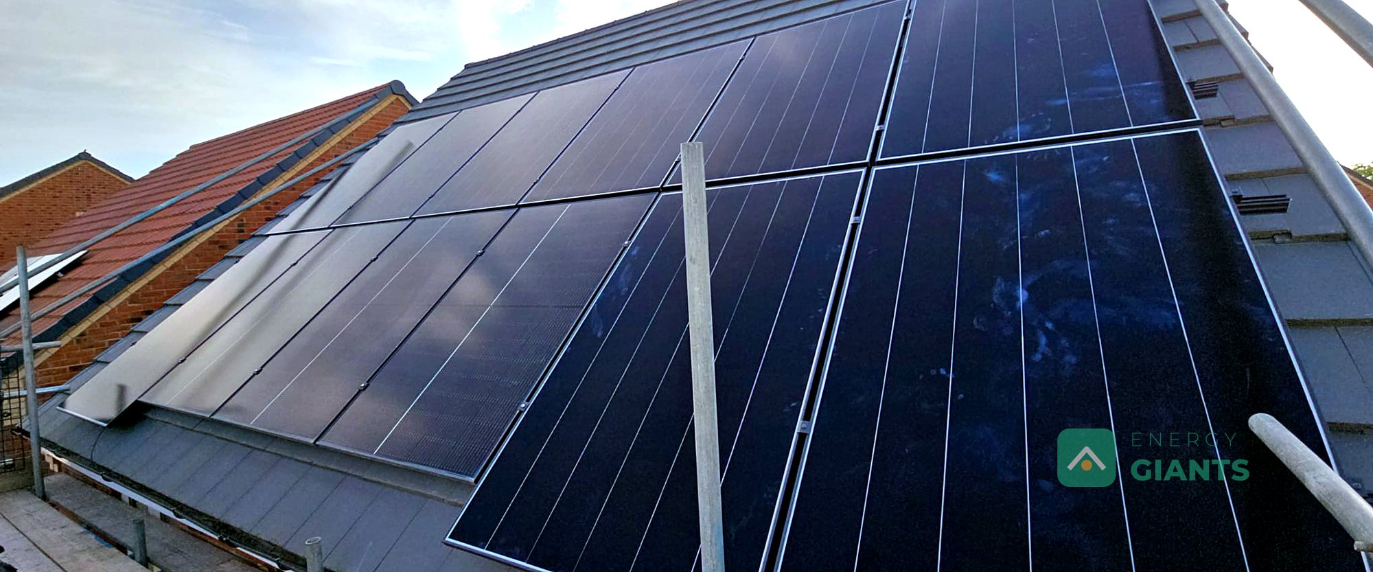 Ten new black Aiko panels on the east facing roof of a brick house in Corby Glen
