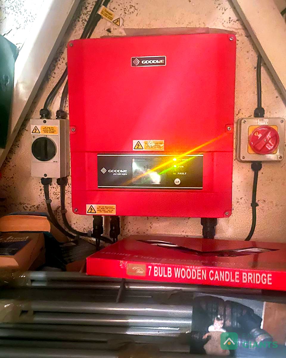The old solar inverter mounted on a board in the loft, before it was removed