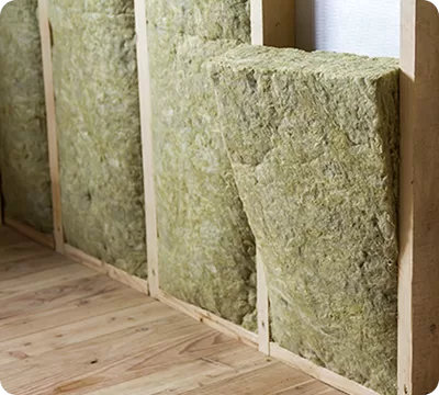 Insulation slabs fitted between timber studs on an internal wall
