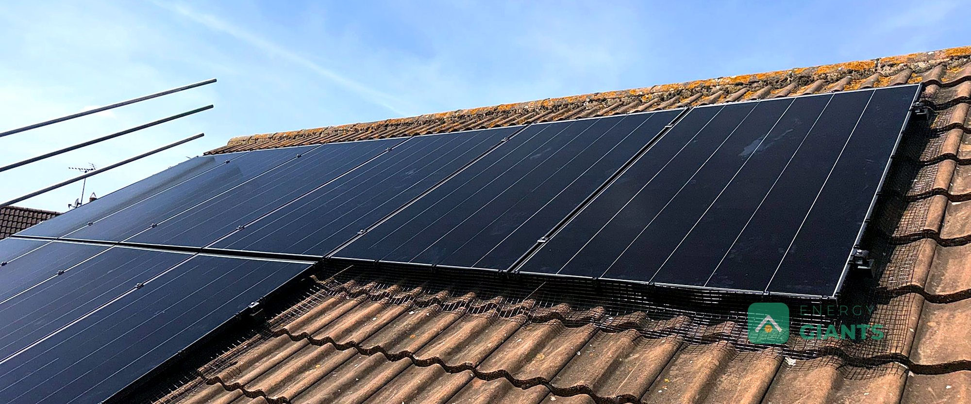 Black Aiko solar panels on the south east facing roof of a brick house in Yaxley