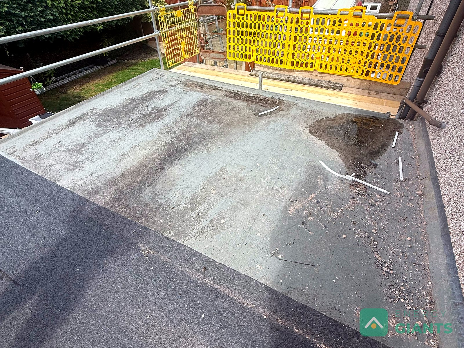 The original felt covering on the rear extension roof in Llanrwst, stained and holding water
