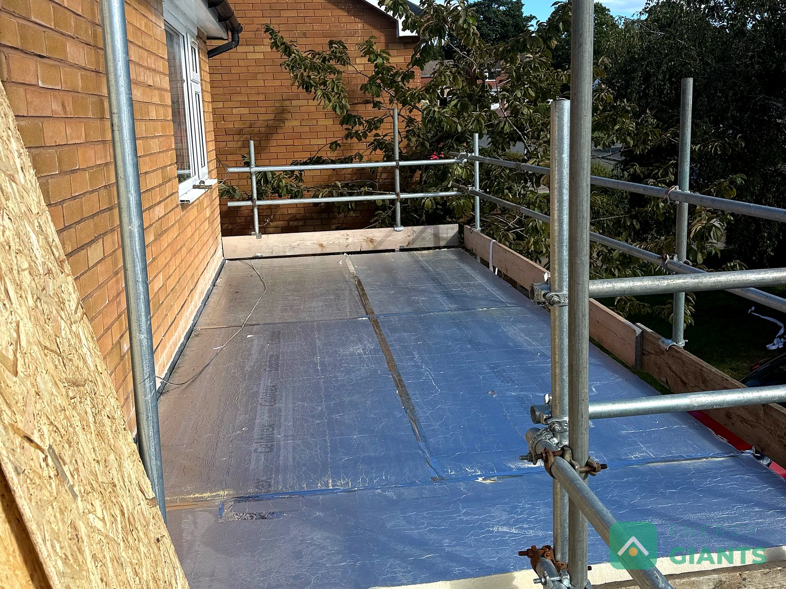 Foil faced PIR insulation boards laid across the whole garage roof, edge to edge