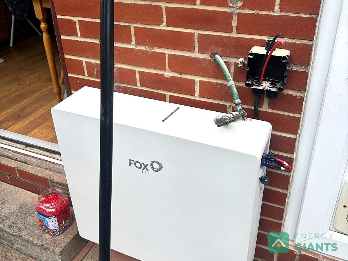 A Fox ESS battery on the rear wall of a brick house in Tingley