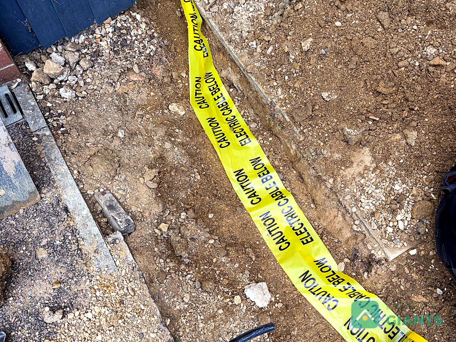 A cable trench with warning tape laid in the ground
