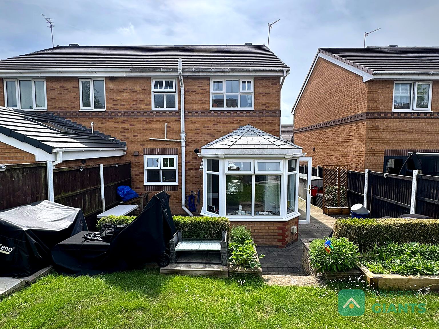 The rear of the house before work started, with a plain tiled roof