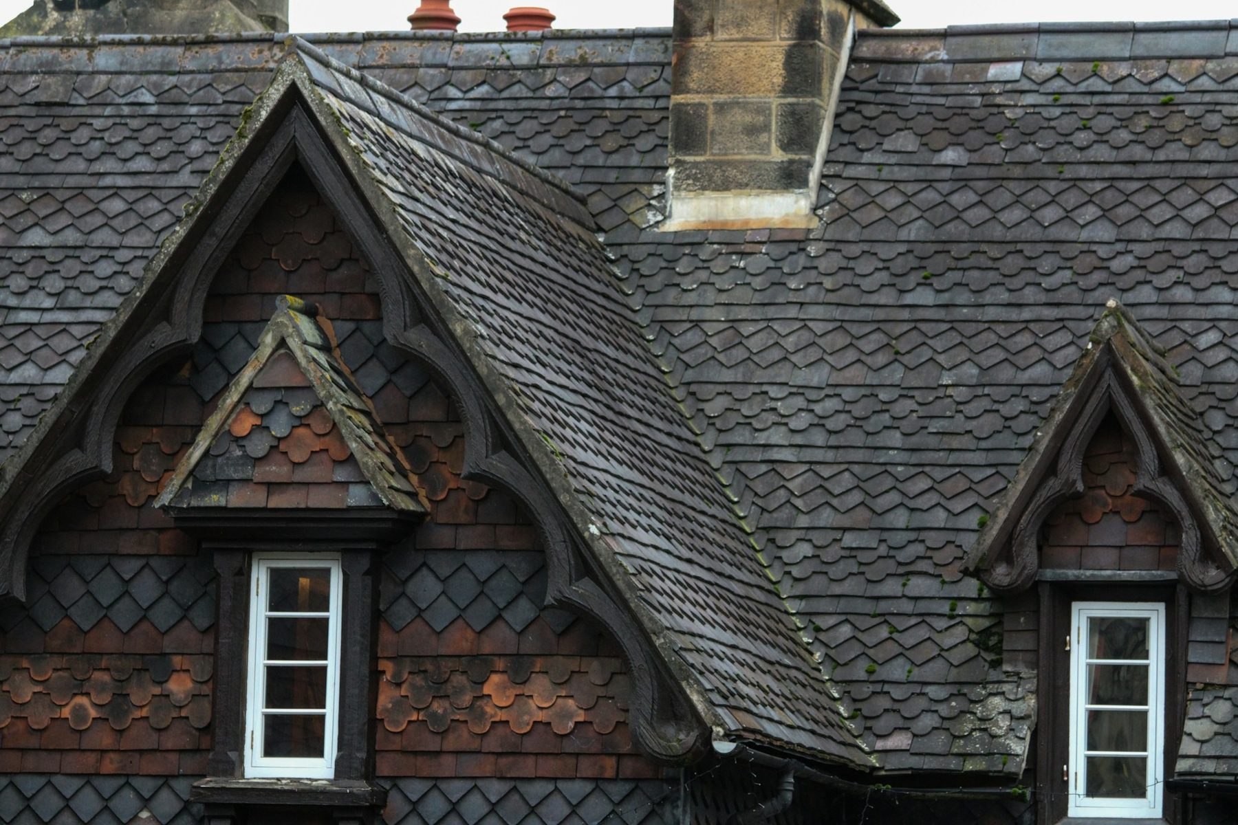 Gabled dormer windows in a slate roof. Illustrative image